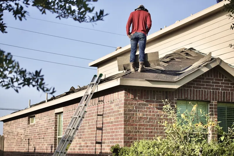 Professional roofer working on a residential roof in St. Matthews
